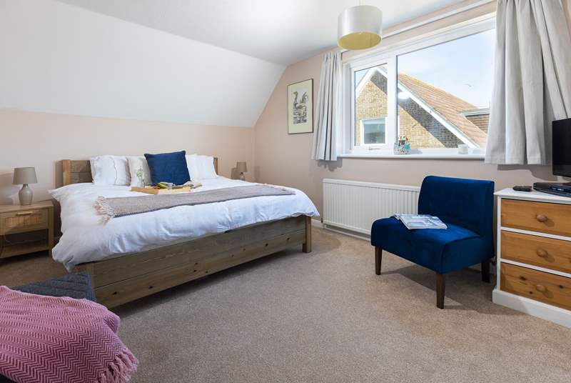 The spacious main bedroom, in the distance from this window you can see the sea.