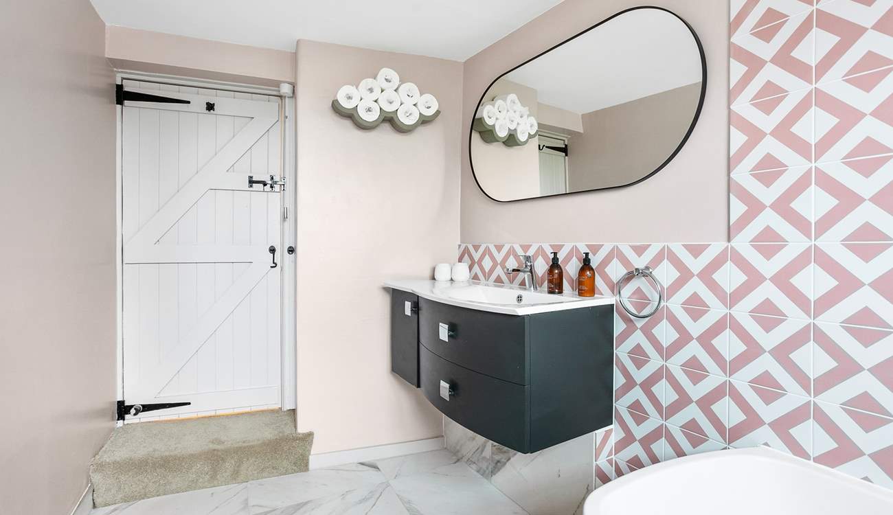 A step leads down into the bathroom.