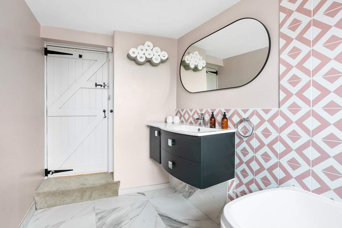 A step leads down into the bathroom.