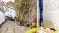 The pretty terrace festooned with fabulous creepers is the perfect place for al fresco dining.