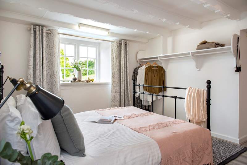 It's a charming room with exposed beams and plenty of space to hang your clothes.