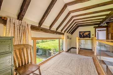 The feature hallway with exposed beams leading to the main bedroom.