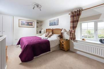 Dual-aspect windows with lovely countryside views make the bedroom very light.