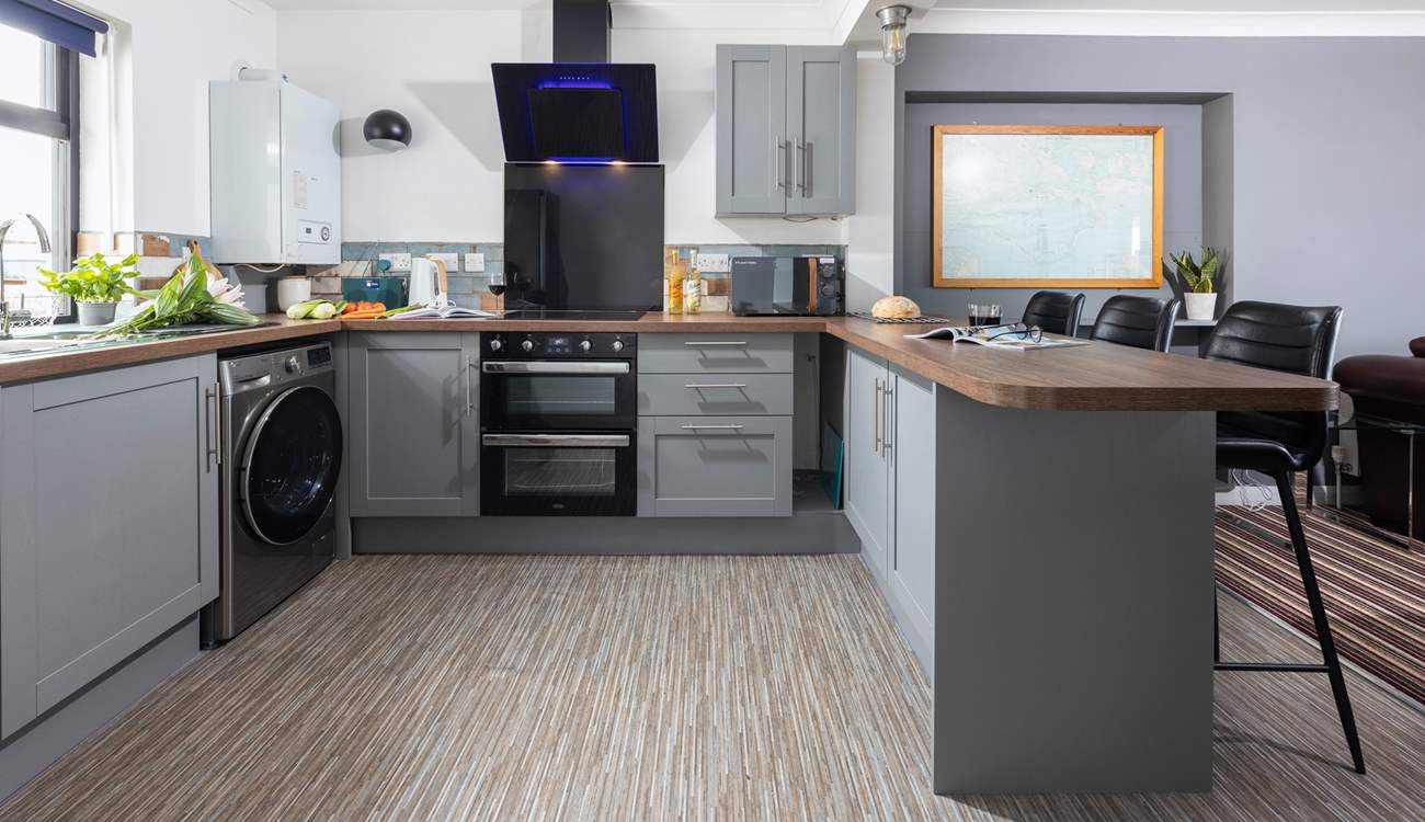 Take a seat at the breakfast-bar, the perfect place to watch the chef cooking up a feast.