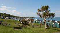 The large, sloped green with children's playground area behind the sea front in Gurnard.