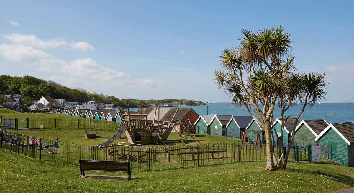 The large, sloped green with children's playground area behind the sea front in Gurnard.