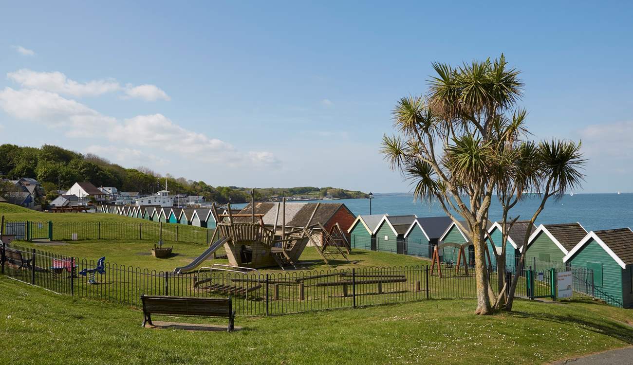 The large, sloped green with children's playground area behind the sea front in Gurnard.