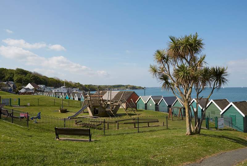 The large, sloped green with children's playground area behind the sea front in Gurnard.