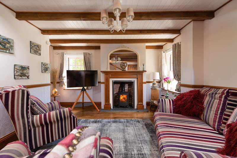 The cute sitting-room, you can light the wood-burner for cosy evenings.