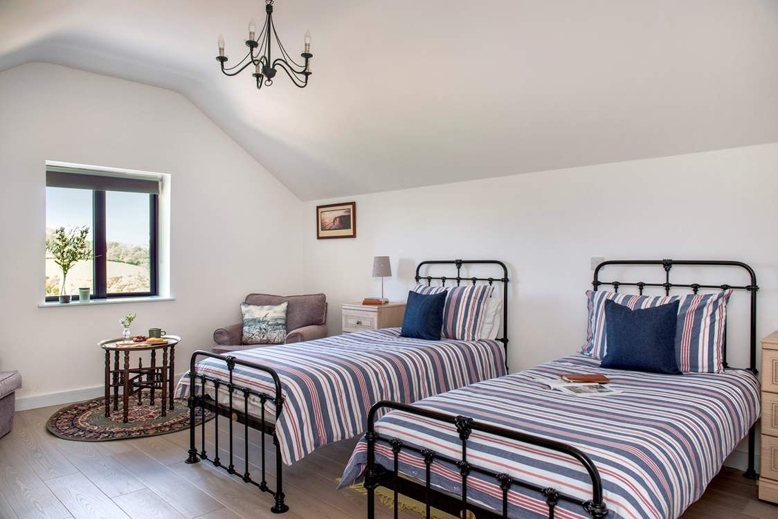 The delightful twin room with a cosy nook for that morning coffee as the sun rises on another day.