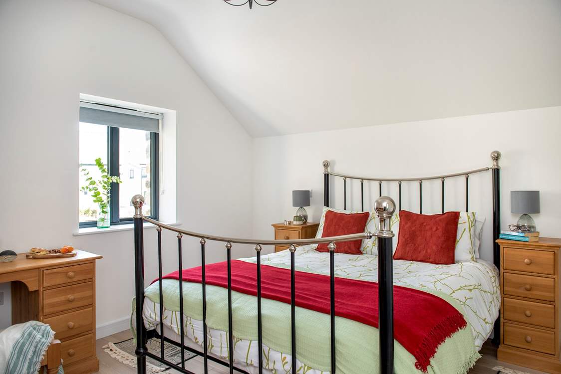 A luxurious king-size bed sits in the centre of bedroom one.