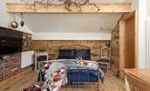 The luxurious bed has a fabulous brass bedstead, giving the cabin a rustic and industrial, yet chic look and feel.  - Thumbnail Image