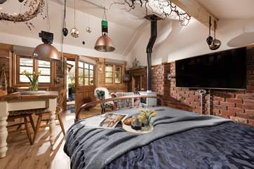 Welcome to Porth Chapel Cabin. Contemporary lighting and a Smart TV marry seamlessly with the quirky interiors.