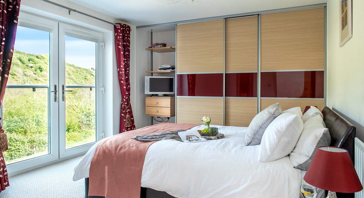 A wonderfully light and airy bedroom, thanks to the large double doors.