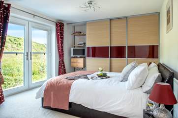 A wonderfully light and airy bedroom, thanks to the large double doors.