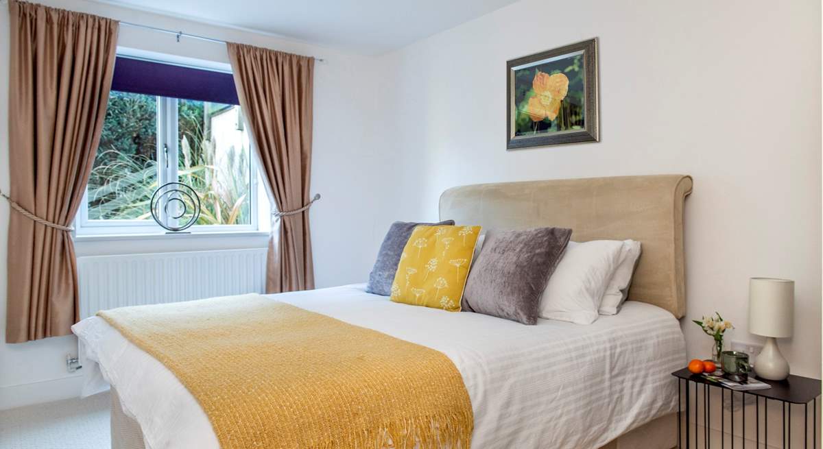 Snuggle up under the covers on the double bed in bedroom four.