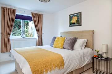 Snuggle up under the covers on the double bed in bedroom four.