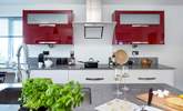 The kitchen has a brilliant vibrant design. - Thumbnail Image