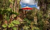 Stunning tropical gardens enclose the hut in nature. - Thumbnail Image