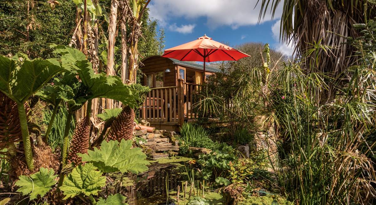 Stunning tropical gardens enclose the hut in nature.