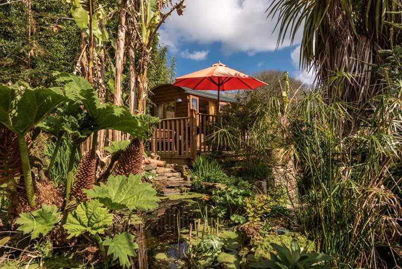 Stunning tropical gardens enclose the hut in nature.