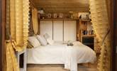 The beautiful double bed provides a superb place to rest as you enter the hut. - Thumbnail Image