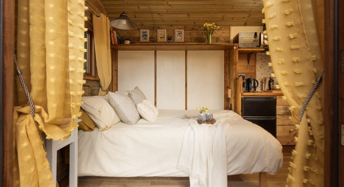 The beautiful double bed provides a superb place to rest as you enter the hut.