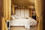 The beautiful double bed provides a superb place to rest as you enter the hut.