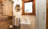 The delightful bathroom is filled with natural light. - Thumbnail Image