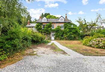 What a beautiful home, with plenty of parking in your enclosed driveway.