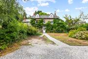 What a beautiful home, with plenty of parking in your enclosed driveway.