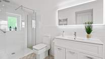 The en suite has a spacious shower.