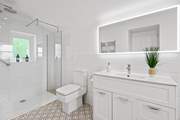 The en suite has a spacious shower.