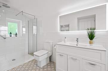 The en suite has a spacious shower.