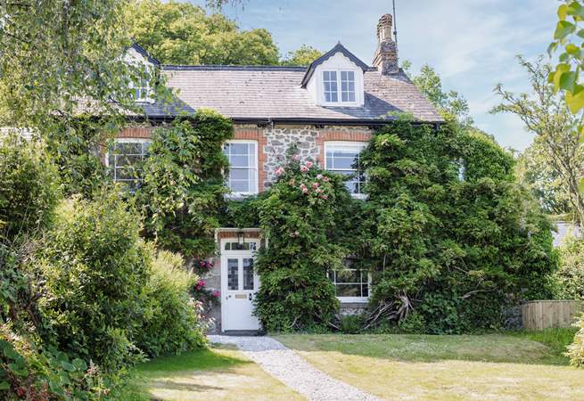 You are welcomed with roses around the door in summer.