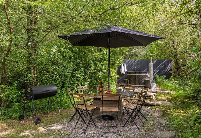 Outdoor living at its best. Please note there is a trickling steam running through the garden and if there is water flowing there are stepping stones to reach the hot tub. 