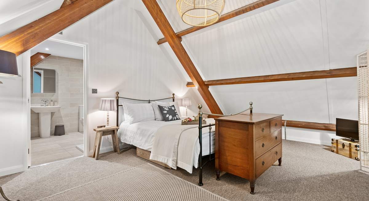 Stunning bedroom three is on the mezzanine floor, up the spiral staircase from the living area. 