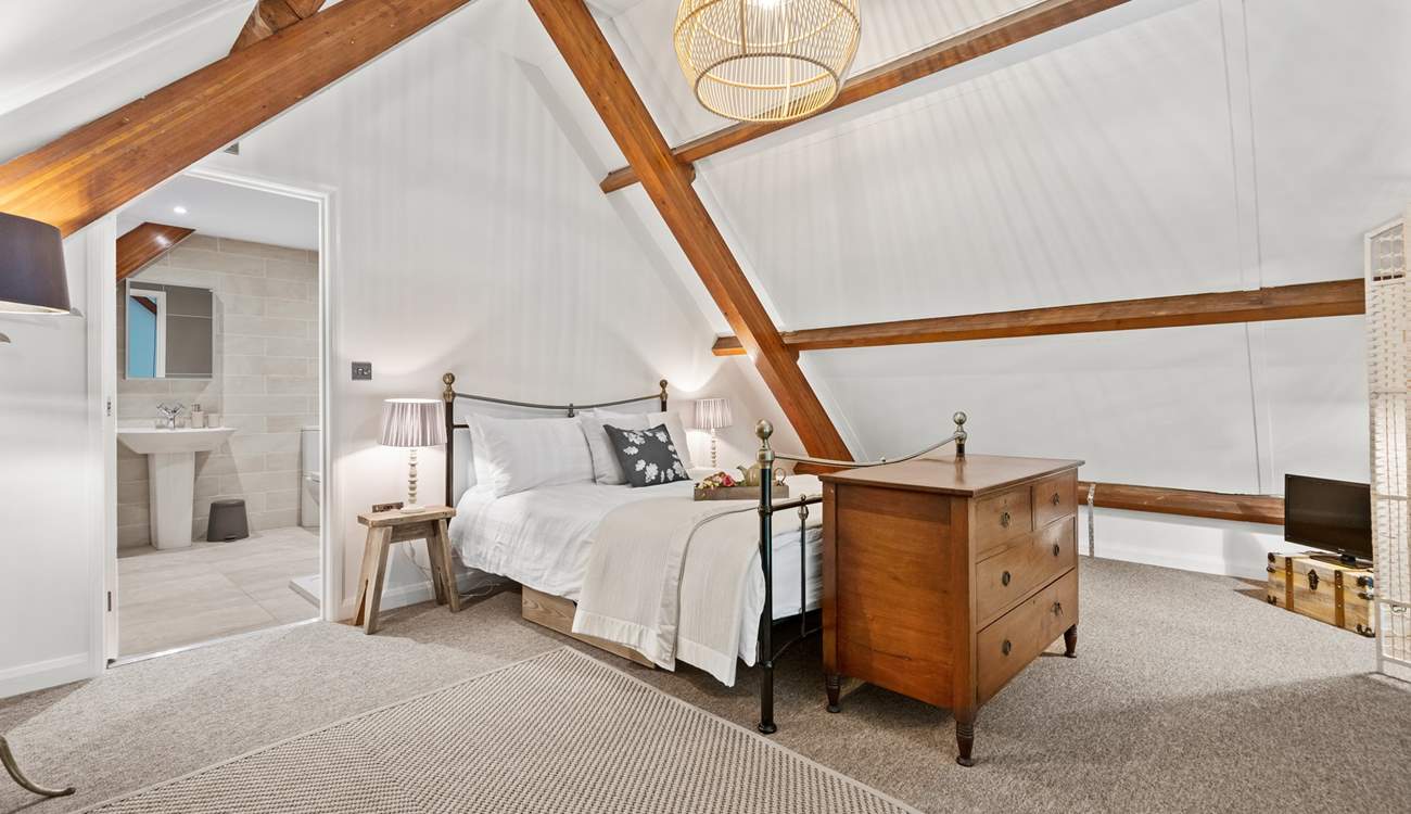 Stunning bedroom three is on the mezzanine floor, up the spiral staircase from the living area. 