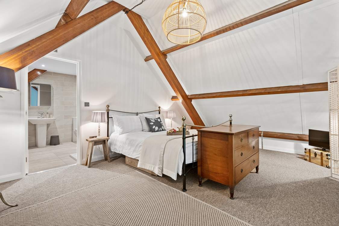 Stunning bedroom three is on the mezzanine floor, up the spiral staircase from the living area.