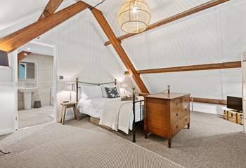 Stunning bedroom three is on the mezzanine floor, up the spiral staircase from the living area. 