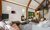 The open plan living space is light and bright with characterful beamed ceilings and windows overlooking the surrounding peaceful woodland. - Thumbnail Image