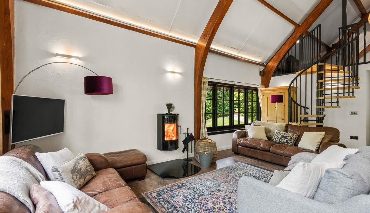 The open plan living space is light and bright with characterful beamed ceilings and windows overlooking the surrounding peaceful woodland.