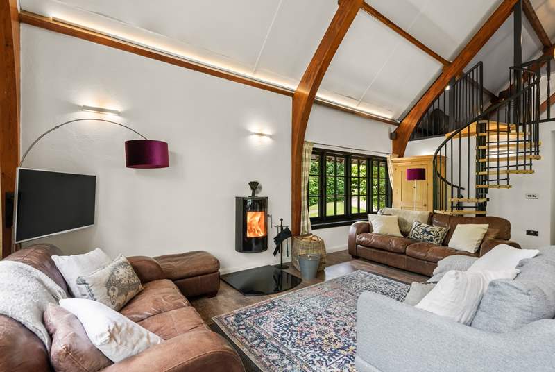 The open plan living space is light and bright with characterful beamed ceilings and windows overlooking the surrounding peaceful woodland.