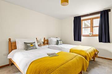 Bedroom 2 is a cheerful room with twin beds.