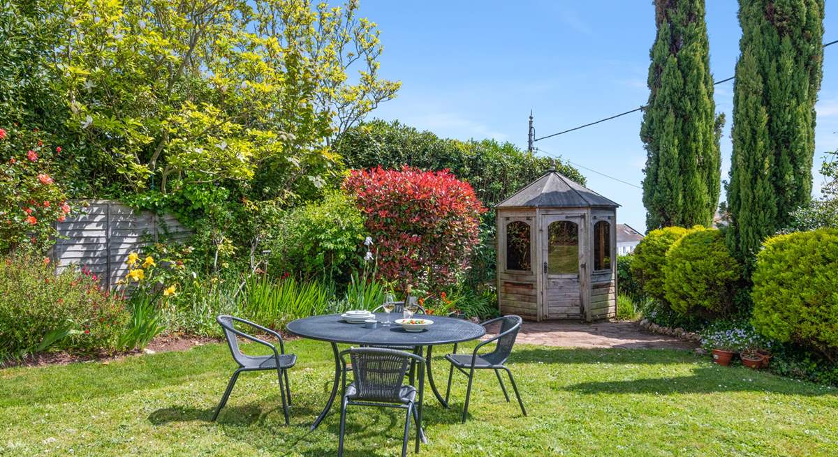 The small table and chairs (8 available) at the bottom of the garden make al fresco dining a dream.