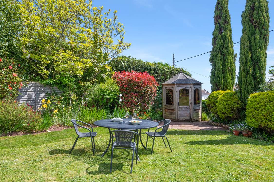 The small table and chairs (8 available) at the bottom of the garden make al fresco dining a dream.