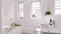 A beautifully finished bathroom joins bedroom one on the half-landing.