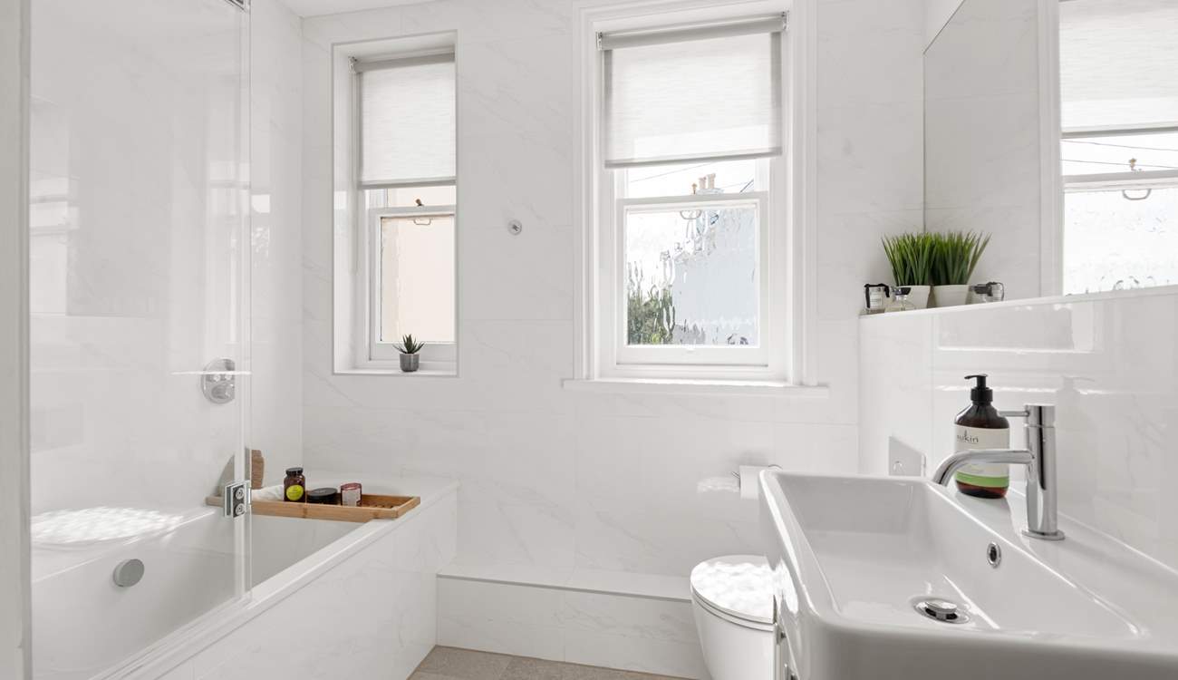 A beautifully finished bathroom joins bedroom one on the half-landing.