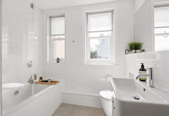 A beautifully finished bathroom joins bedroom one on the half-landing.
