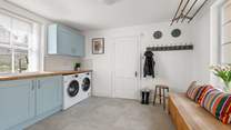 The handy utility-room is great for storing muddy boots.